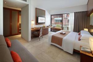 勒吉安The Magani Hotel and Spa的酒店客房设有一张大床和一张书桌。