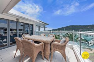 埃尔利海滩2 bedroom Penthouse at the Boathouse的阳台的天井配有桌椅