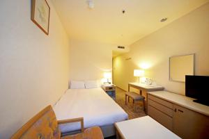 旭川旭川东洋酒店的酒店客房设有一张床、一张书桌和一台电视机。