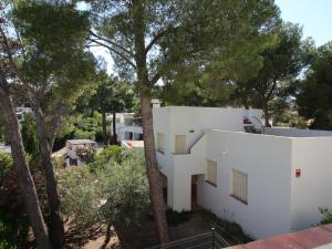 兰卡Casa con Jardín a 100m de la Playa de la Farella, Wifi y Garaje Privado - ES-228-175的前方有树木的白色建筑