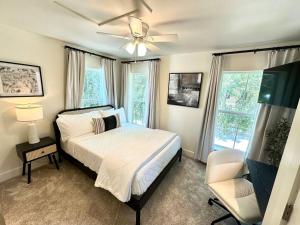 海泉市Cute and Cozy Comfy Birds Junior Cottage - 1 mile to Dwntn Ocean Springs, near Beach with Golf Cart的一间卧室配有一张床和吊扇