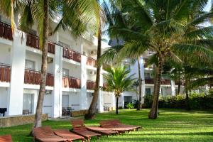 蒙巴萨航海家海滩度假酒店的前面有棕榈树的酒店