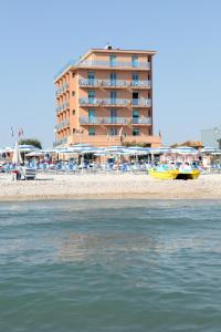 马洛塔马洛塔阿芭佳俱乐部酒店的海滩上的酒店,后方是一座建筑