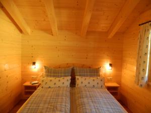 巴特霍夫加施泰因Haus Schwaiger的木制客房内的一间卧室,配有一张床