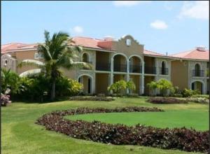 蓬塔卡纳高尔夫套房酒店的院子里有棕榈树的大房子