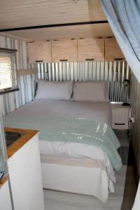 KlipdriftNdlovu Tiny Home Dinokeng的一间卧室,卧室内配有一张大床