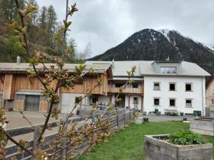 SuschB&B im Ökohaus in Susch的一座白楼,背景是一座山