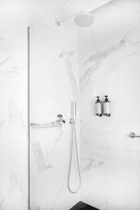 雅典Luwian Athens Boutique Hotel的一间设有白色大理石墙壁和淋浴的浴室