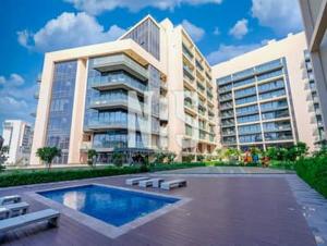 阿布扎比Jupiter Saadiyat Beach New York Abu Dhabi university Studio Apartment的一座大型建筑,前面设有一个游泳池