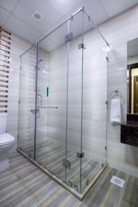 麦纳麦贝尔塔公寓式酒店的一间带卫生间的浴室内的玻璃淋浴间