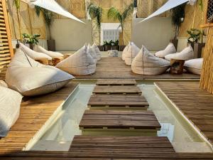 雅典Athens The L7 Str - Luxury Boutique Collection Hotel的客房 - 带枕头和游泳池,位于木地板
