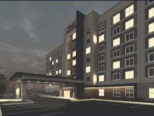 纽瓦克Hampton Inn & Suites By Hilton- Newark Airport Elizabeth的灯光照亮酒店大楼的 ⁇ 染