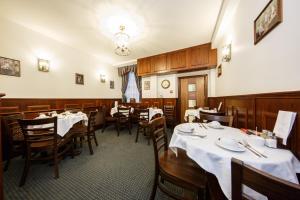 伦敦摄政大楼酒店的一间在房间内配有桌椅的餐厅