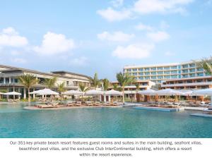 拉斯阿尔卡麦InterContinental Ras Al Khaimah Mina Al Arab Resort & Spa, an IHG Hotel的一个带椅子和遮阳伞的度假村游泳池的 ⁇ 染