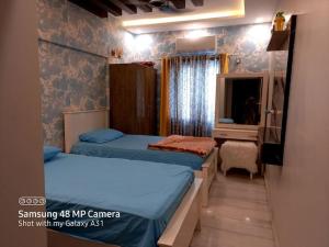 卡拉奇2 beds apartment banglow facing的一间带两张床的卧室和一台电视