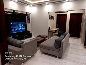 卡拉奇2 beds apartment banglow facing的带沙发和平面电视的客厅