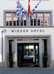 苏黎世Widder Hotel - Zurichs luxury hideaway的一座建筑,在旅馆前有两面旗帜