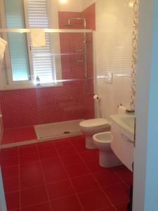 切萨雷奥港Paradise Beach的红色的浴室设有2个卫生间和淋浴