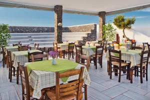 卡马利马卡里奥斯酒店的庭院内的餐厅,配有桌椅