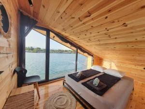 乌尔齐尼modernes Holzhaus, Cabin, auf dem Fluss, wenige Meter zum Meer的水景小屋内的一张床位