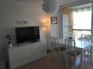 阿德耶科帕卡巴纳公寓的客厅配有电视和桌椅