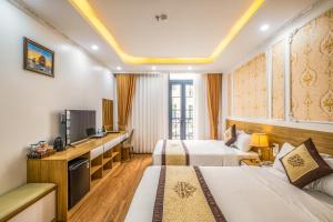 下龙湾Thành Đô Hotel Hạ Long的酒店客房设有两张床和电视。