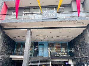 新德里Qotel Hotel Chhatarpur - Opp Tivoli Garden的建筑物前面的商店,上面有标志