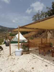 米哈斯Glamping Finca el Olivo的一个带野餐桌和帐篷的凉亭