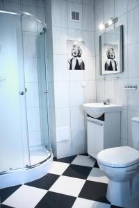 波兹南利欧旅舍的带淋浴卫生间和盥洗盆的浴室