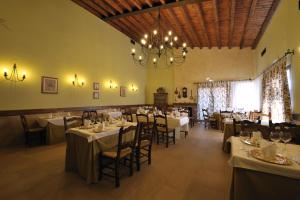 Cuevas del ValleHotel Rural y Restaurante, Rinconcito de Gredos的一间带桌椅和吊灯的用餐室