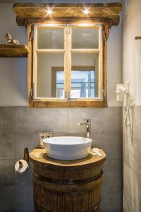 塞尔瓦迪加尔代纳山谷Chalet Da Mont的木桌上设有白色大水槽的浴室
