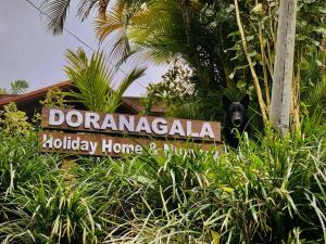 马特莱Doranagala Holiday Home的一只黑狗站在标志旁边