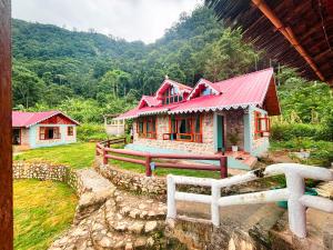 RongliLungZhong Retreat Silk Route的一间设有红色屋顶和围栏的小房子