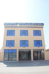 Ḩilf马安公寓的一栋带蓝色窗户的办公楼
