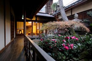 京都正庵旅馆的大楼内带粉红色花卉的阳台