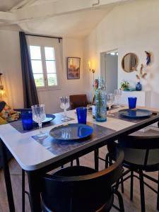 索米尔Appartement Loire et Château, Hyper Centre, vue Loire, Linge inclus, 3ème étage的一张桌子,上面有蓝色的盘子和玻璃杯