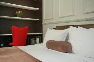 贝尔格莱德贝尔格莱特尊贵公寓的一间卧室配有一张红色椅子的床
