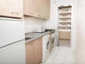 卡尔佩图尔马利纳尤尼图尔萨公寓的厨房配有洗衣机、烘干机和冰箱。