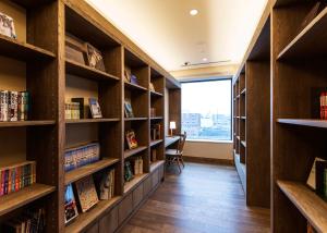 旭川旭川JR酒店的图书馆设有书架和木架