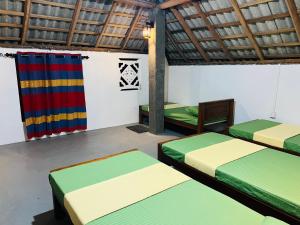 雅拉Turtle bay Hostel -Yala的带四张床和旗帜的客房