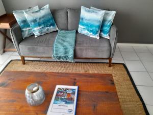 布鲁堡史特兰Cape Town Beachfront Accommodation in Blouberg的客厅配有沙发和桌子