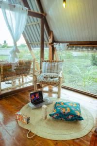 南威Unique A-Frame Cabin near to Nungwi Beach的一间带椅子和笔记本电脑的桌子间