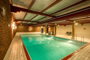 拉尔特Hotel Restaurant De Zwaan的大楼内的大型游泳池