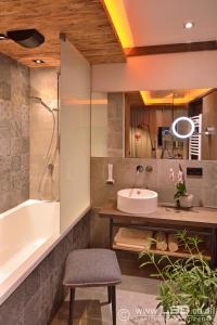 蒂罗尔州圣约翰旁腾豪夫博尔酒店的带浴缸、水槽和浴缸的浴室