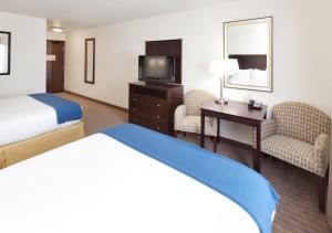 Gretna奥马哈I80州际公路智选假日酒店的酒店客房设有一张床、一张书桌和一台电视机。