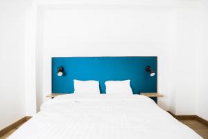 列日Smartflats City - Perron的一张白色大床,带有蓝色床头板