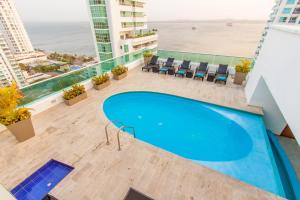 卡塔赫纳奥兰格卡塔赫纳旅行者酒店的一座享有海滩美景的建筑屋顶上的游泳池