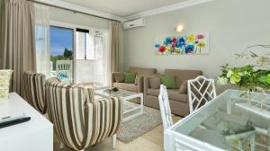 Estepona奥纳俱乐部本纳维斯塔公寓式酒店的客厅配有沙发、椅子和桌子