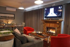 VryburgGame View Lodge的客厅设有壁炉和电视。