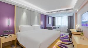 深圳Lavande Hotel Shenzhen Bay Houhai Avenue的酒店客房设有一张白色大床和一张书桌